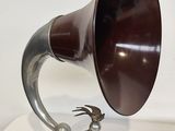 a silver and brown horn on a wooden stand
