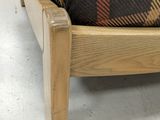 a couch with a plaid blanket on it in a room