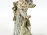 figurine of a woman with a hat and a bag