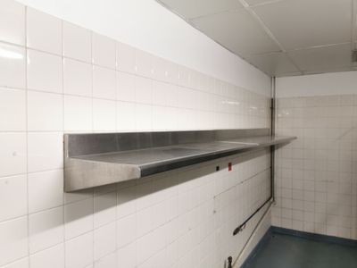 une image d'une cuisine commerciale avec des plans de travail en acier inoxydable