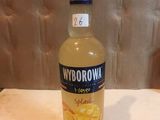a bottle of liquor sitting on a table in front of a wall