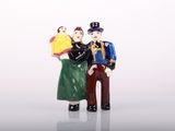 two figurines of a man and a woman standing next to each other