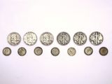 a lot of coins that are on a white surface