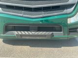 a close up of a green truck with a grill