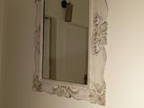 a mirror on the wall above a sink in a bathroom