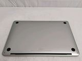 the back of a silver laptop computer sitting on top of a white surface