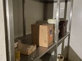 a metal shelf with boxes on it in a room