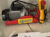 a picture of a box of wire and a blower on a shelf