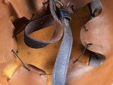 a brown leather helmet with a leather strap on it