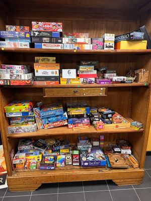a wooden shelf filled with lots of toys in a store