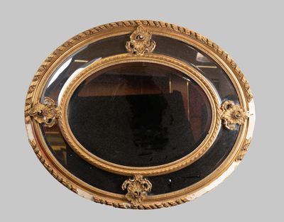 a mirror with a gold frame on the wall