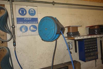 a blue hose attached to a wall in a garage