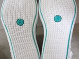 the soles of a pair of white shoes with blue trim
