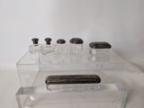 clear acrylic display case with four bottles and a cell phone