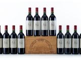 six bottles of red wine in a wooden crate on a white background