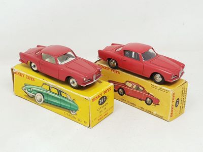 two red toy cars are sitting on top of a yellow box