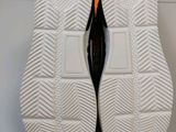 the soles of a pair of tennis shoes on a white surface