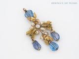a picture of a brooch with blue and white beads