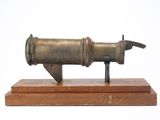 a small metal object on a wooden stand