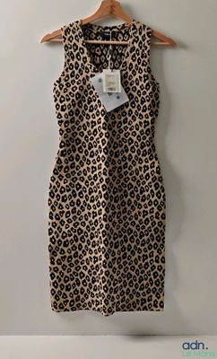 leopard print dress on hanger against white wall in room