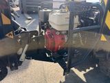 a small machine that is parked on the side of the road
