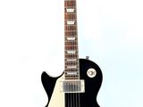 an image of a black electric guitar on a stand on a white background