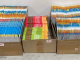 plusieurs cartons de livres empilés les uns sur les autres dans une pièce