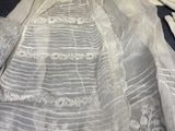 an image of a wedding dress and veil on a bed