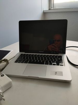 a laptop computer sitting on top of a white table