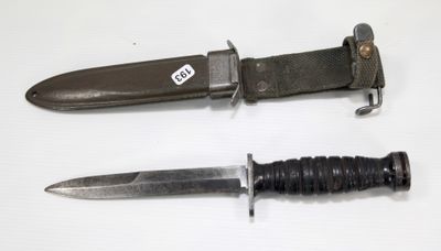 two different types of knives on a white surface