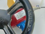 a steering wheel with a blue handle and a red valve