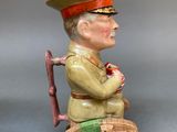 pair of ceramic figurines of a soldier and a soldier with a cane