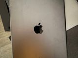 someone is holding an apple ipad in their hand on a table
