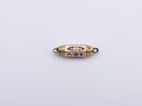 an image of a gold plated bead with a blue and white design