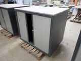 two cabinets that are sitting on pallets in a warehouse