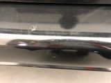 a close up of a car bumper with a small bug on it