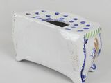a white toaster with blue and green designs on it