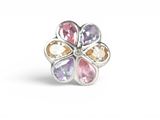 a close up of a flower shaped ring with multi colored stones