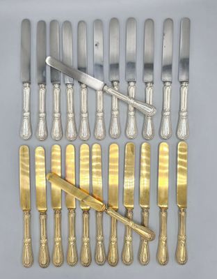 a lot of silverware on a table with a knife and fork