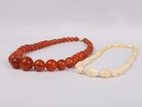 a pair of red and white jade beaded necklaces