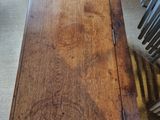 a wooden table with a wooden top on a carpeted floor