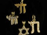 a set of four gold and diamond jewish charms