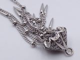 a silver necklace with a bunch of scissors hanging from it