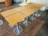 four tables that are sitting on the floor in the room