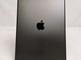 the back of an ipad with a black apple logo on it
