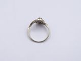 a close up of a silver ring on a white surface