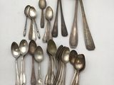 a lot of silver spoons and spoon spoons on a table