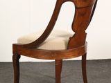 an image of a wooden chair with beige upholstered seat