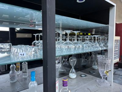 many empty wine glasses sitting on the bar counter
