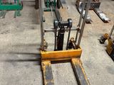 a fork lifter that is sitting in a warehouse